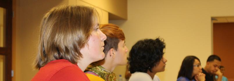 Students looking to the right and listening during a workshop session