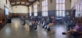 Panorama of Latzer Hall with Akua Forkuo-Sekyere presenting to campus and community members.